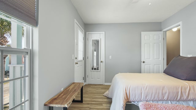 bedroom featuring baseboards, a ceiling fan, and wood finished floors