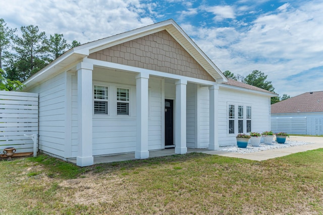 exterior space with fence and a lawn