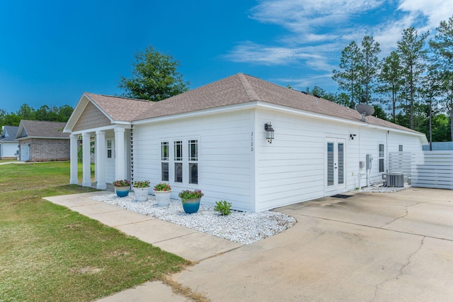 3120 Pinot Way, Crestview, FL 32536 - view of side of home with french doors, a lawn, a patio area, cooling unit, and roof with shingles