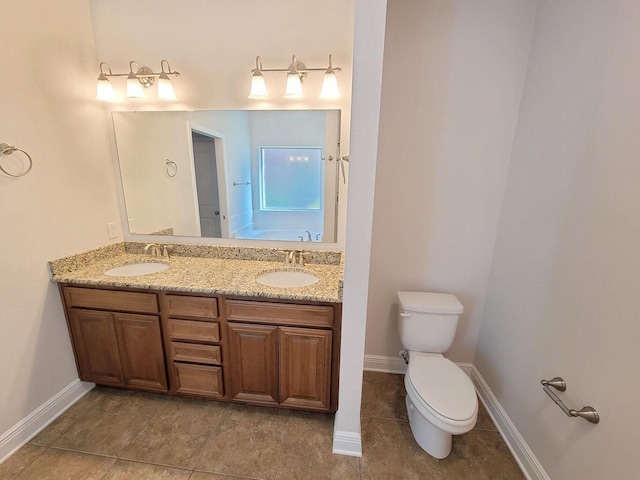 1921 Mooring Dr, Navarre, FL 32566 - bathroom with toilet, double vanity, baseboards, and tile patterned floors