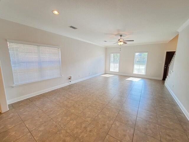 1921 Mooring Dr, Navarre, FL 32566 - unfurnished room featuring ceiling fan, crown molding, baseboards, tile patterned floors, and stairway