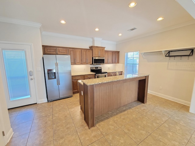 1921 Mooring Dr, Navarre, FL 32566 - kitchen featuring appliances with stainless steel finishes, light stone counters, light tile patterned flooring, recessed lighting, and crown molding