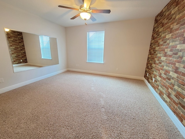 1921 Mooring Dr, Navarre, FL 32566 - carpeted spare room with brick wall, baseboards, and a ceiling fan