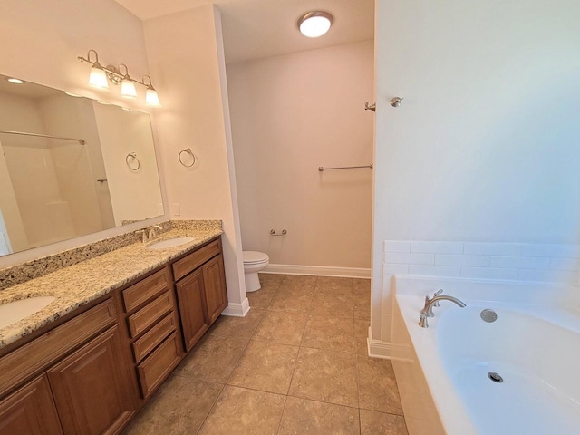 1921 Mooring Dr, Navarre, FL 32566 - full bathroom featuring a bath, toilet, double vanity, tile patterned flooring, and baseboards