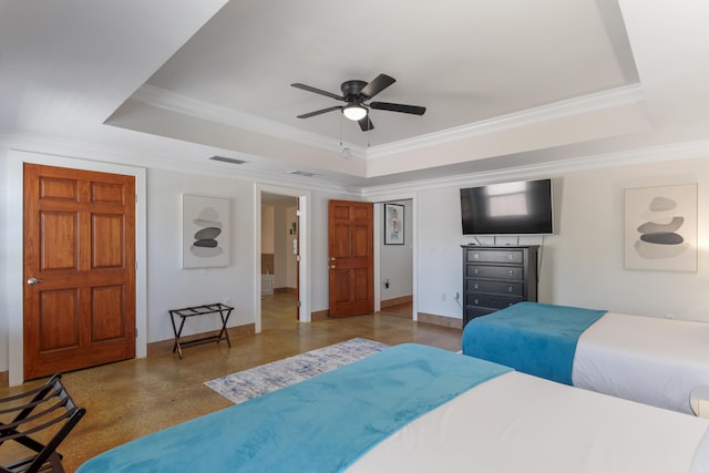 bedroom featuring a tray ceiling, visible vents, and ornamental molding