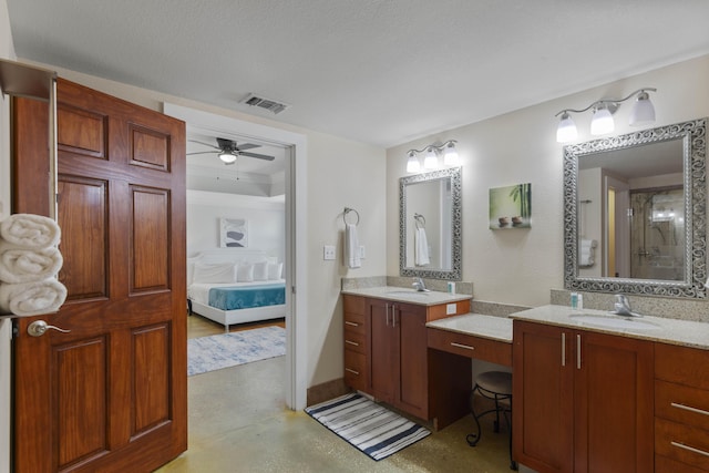 ensuite bathroom featuring a ceiling fan, visible vents, two vanities, a sink, and connected bathroom