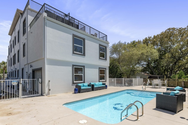 view of swimming pool with an outdoor hangout area, fence, a fenced in pool, and a patio area