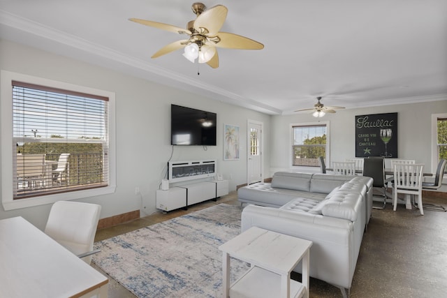 living area featuring a ceiling fan, baseboards, and ornamental molding