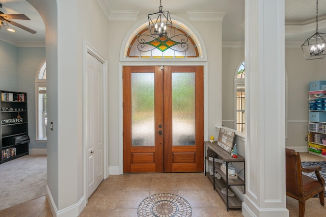 4594 Nautical Ct, Destin, FL 32541 - tiled foyer featuring french doors, ornamental molding, and ceiling fan with notable chandelier