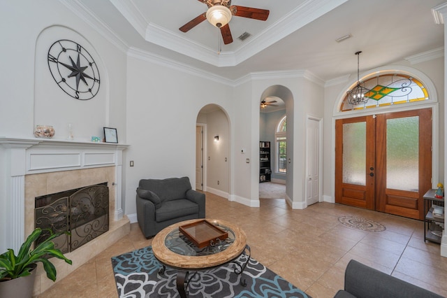 4594 Nautical Ct, Destin, FL 32541 - foyer entrance featuring crown molding, arched walkways, a ceiling fan, a tile fireplace, and visible vents