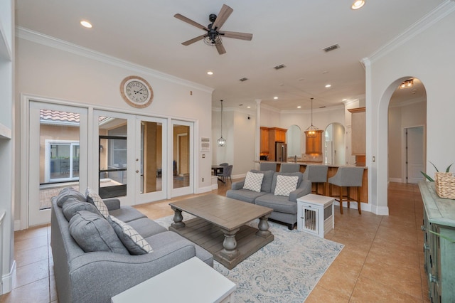 4594 Nautical Ct, Destin, FL 32541 - living area featuring arched walkways, french doors, a ceiling fan, light tile patterned floors, and ornamental molding