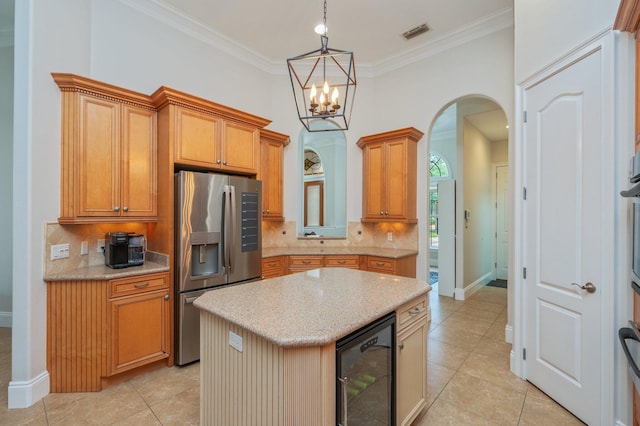 4594 Nautical Ct, Destin, FL 32541 - kitchen with visible vents, decorative backsplash, beverage cooler, stainless steel refrigerator with ice dispenser, and arched walkways