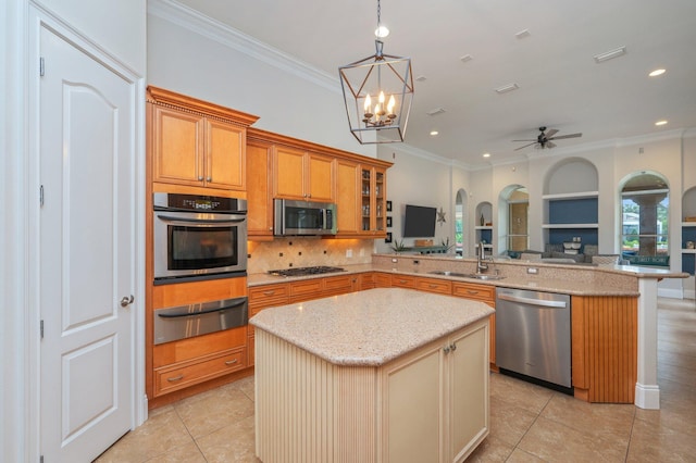 4594 Nautical Ct, Destin, FL 32541 - kitchen with crown molding, arched walkways, a sink, a warming drawer, and stainless steel appliances