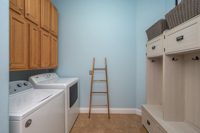 4594 Nautical Ct, Destin, FL 32541 - laundry area with baseboards, cabinet space, and washing machine and dryer