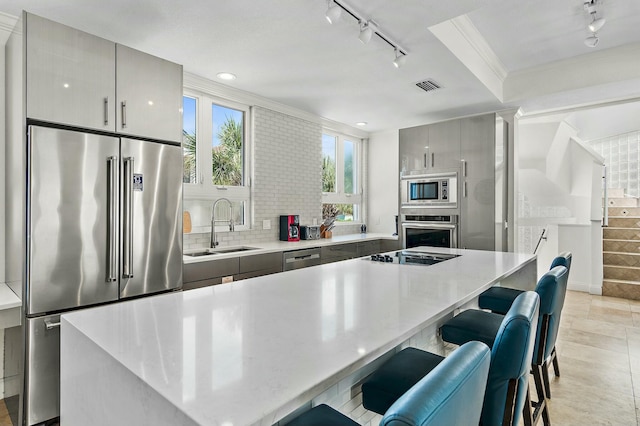 4835 Ocean Blvd, Destin, FL 32541 - kitchen featuring rail lighting, visible vents, modern cabinets, a sink, and appliances with stainless steel finishes