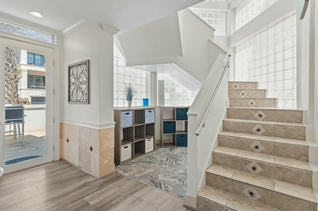 4835 Ocean Blvd, Destin, FL 32541 - staircase featuring recessed lighting, wood finished floors, crown molding, and wainscoting