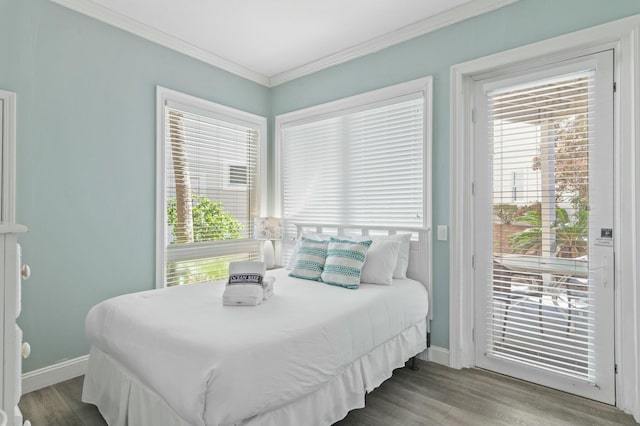 4835 Ocean Blvd, Destin, FL 32541 - bedroom with multiple windows, wood finished floors, ornamental molding, and access to exterior