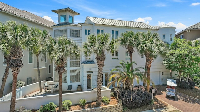 4835 Ocean Blvd, Destin, FL 32541 - view of front facade featuring fence, a garage, a standing seam roof, decorative driveway, and metal roof