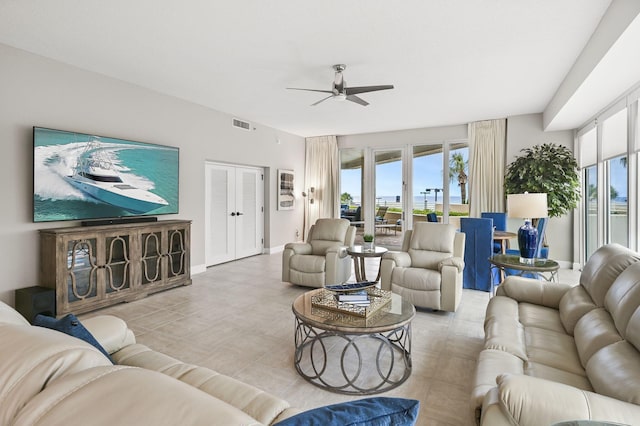 living room featuring french doors, a healthy amount of sunlight, ceiling fan, and visible vents
