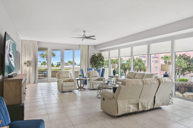 living area featuring light tile patterned floors and a ceiling fan