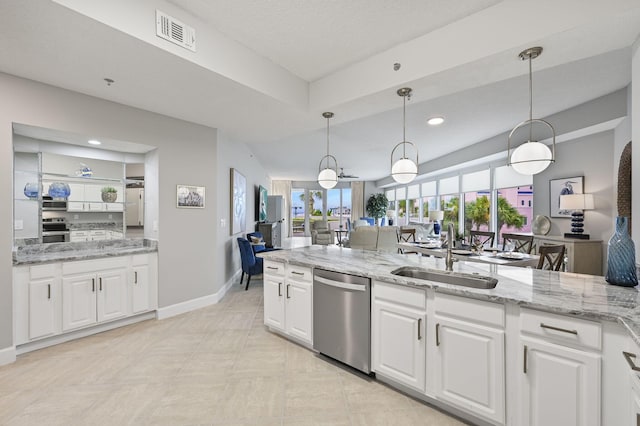 kitchen with white cabinets, visible vents, a sink, stainless steel appliances, and open floor plan