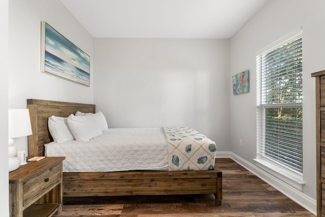 bedroom featuring dark wood-type flooring and baseboards