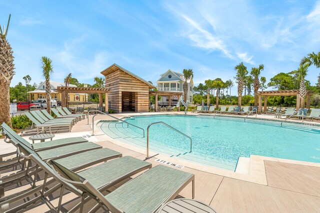 LOT35 String Lily Cv, Santa Rosa Beach, FL 32459 - community pool featuring a pergola, a patio area, and fence
