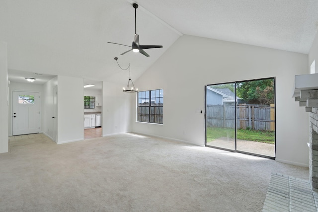 2106 Wilderness Path, Fort Walton Beach, FL 32547 - unfurnished living room featuring a fireplace, a ceiling fan, high vaulted ceiling, a chandelier, and carpet flooring