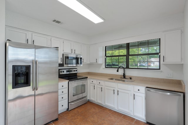 2106 Wilderness Path, Fort Walton Beach, FL 32547 - kitchen with stainless steel appliances, white cabinets, light countertops, and tile patterned floors