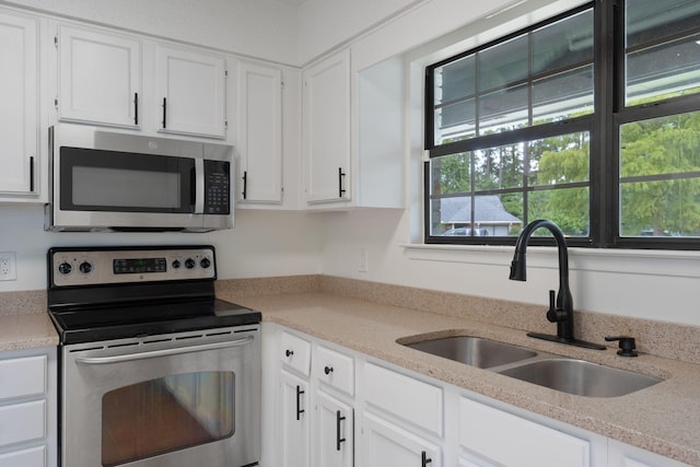 2106 Wilderness Path, Fort Walton Beach, FL 32547 - kitchen with appliances with stainless steel finishes, white cabinets, and light countertops