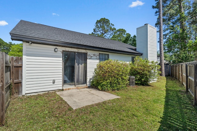 2106 Wilderness Path, Fort Walton Beach, FL 32547 - back of property with a shingled roof, a fenced backyard, a patio area, and a chimney