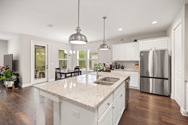 kitchen with a sink, appliances with stainless steel finishes, white cabinetry, recessed lighting, and dark wood-type flooring