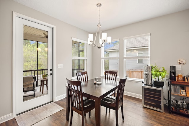 dining space featuring dark wood-type flooring, beverage cooler, baseboards, and a chandelier