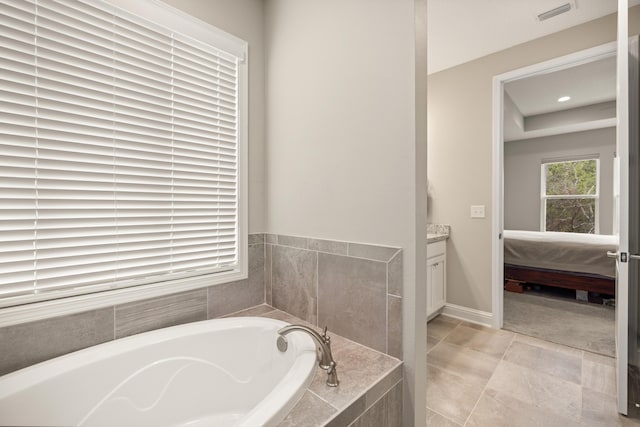 full bathroom with vanity, baseboards, ensuite bath, a bath, and visible vents