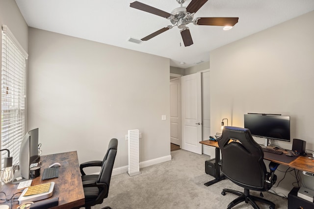 home office with light carpet, ceiling fan, baseboards, and visible vents