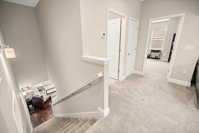 stairway with carpet flooring and baseboards