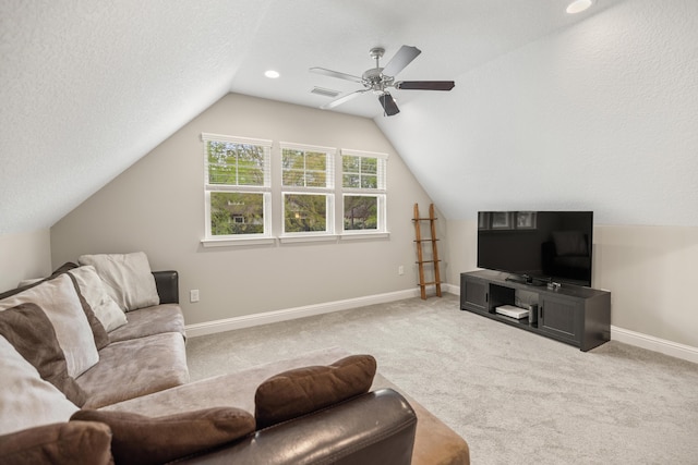 carpeted living room featuring ceiling fan, a textured ceiling, visible vents, lofted ceiling, and baseboards