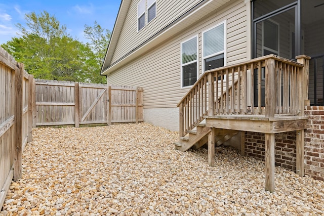 view of yard with a fenced backyard and a gate