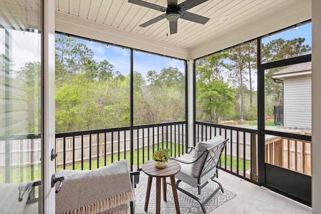 sunroom / solarium featuring ceiling fan and a wealth of natural light