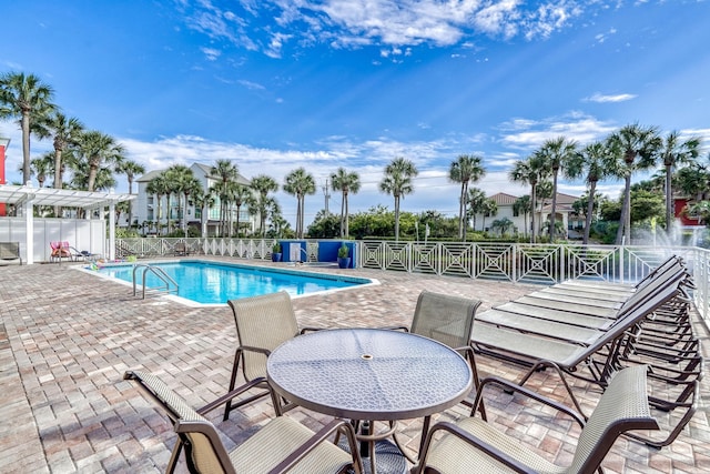 pool featuring a patio area, fence, and a pergola