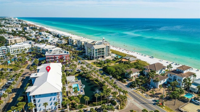 drone / aerial view with a water view and a beach view