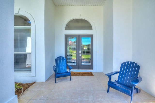 property entrance with french doors, a patio, and stucco siding