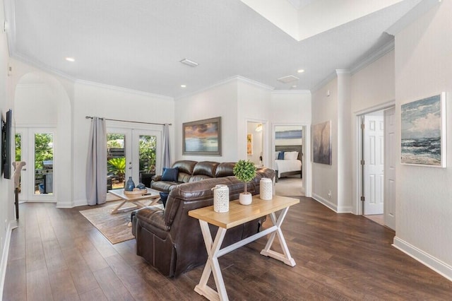living area featuring baseboards, arched walkways, ornamental molding, dark wood-type flooring, and french doors