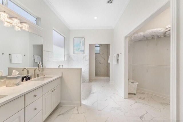 full bathroom with ornamental molding, marble finish floor, a sink, walk in shower, and double vanity