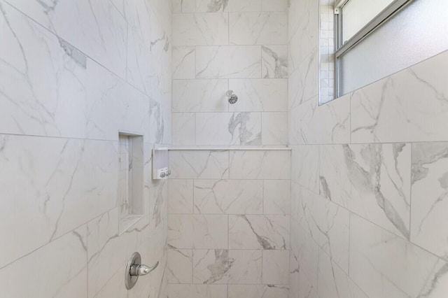 full bathroom with a tile shower