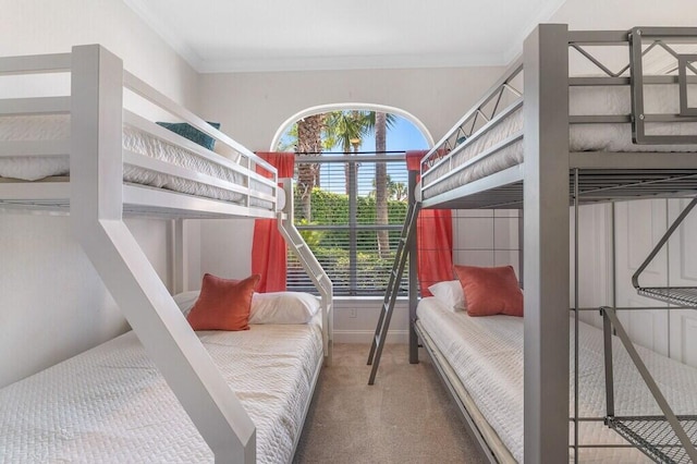 bedroom featuring ornamental molding, baseboards, and carpet