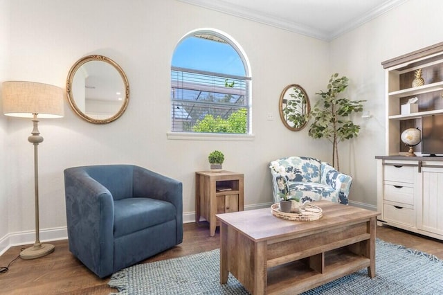 living area featuring crown molding, baseboards, and wood finished floors