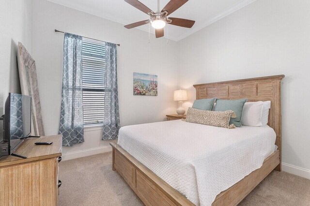 bedroom with baseboards and light colored carpet