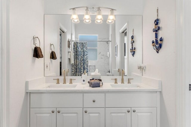 full bath featuring a shower with shower curtain, double vanity, and a sink