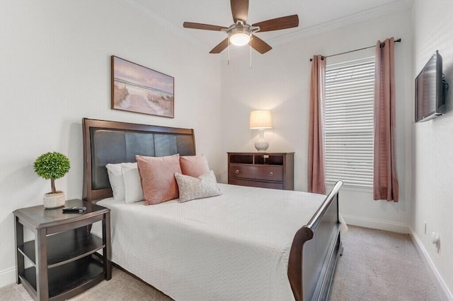bedroom with light carpet, multiple windows, baseboards, and ornamental molding